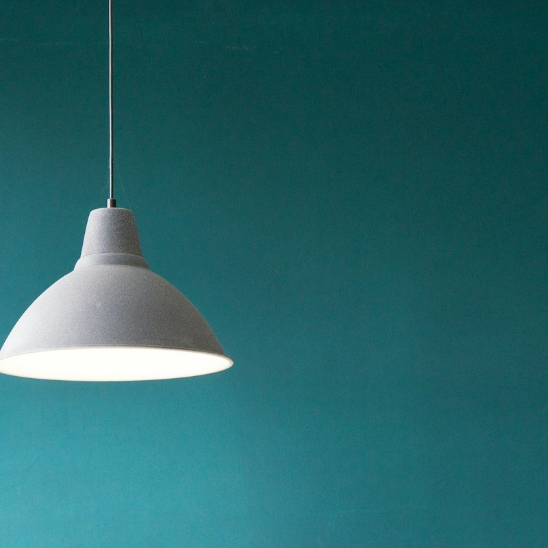Electrician Installing Modern Dining Room Chandelier in Boise
